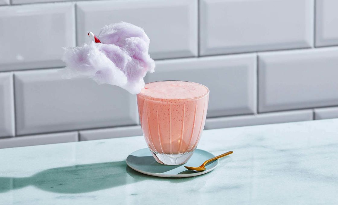 Glass of Cotton Candy Milkshake against a tiled wall