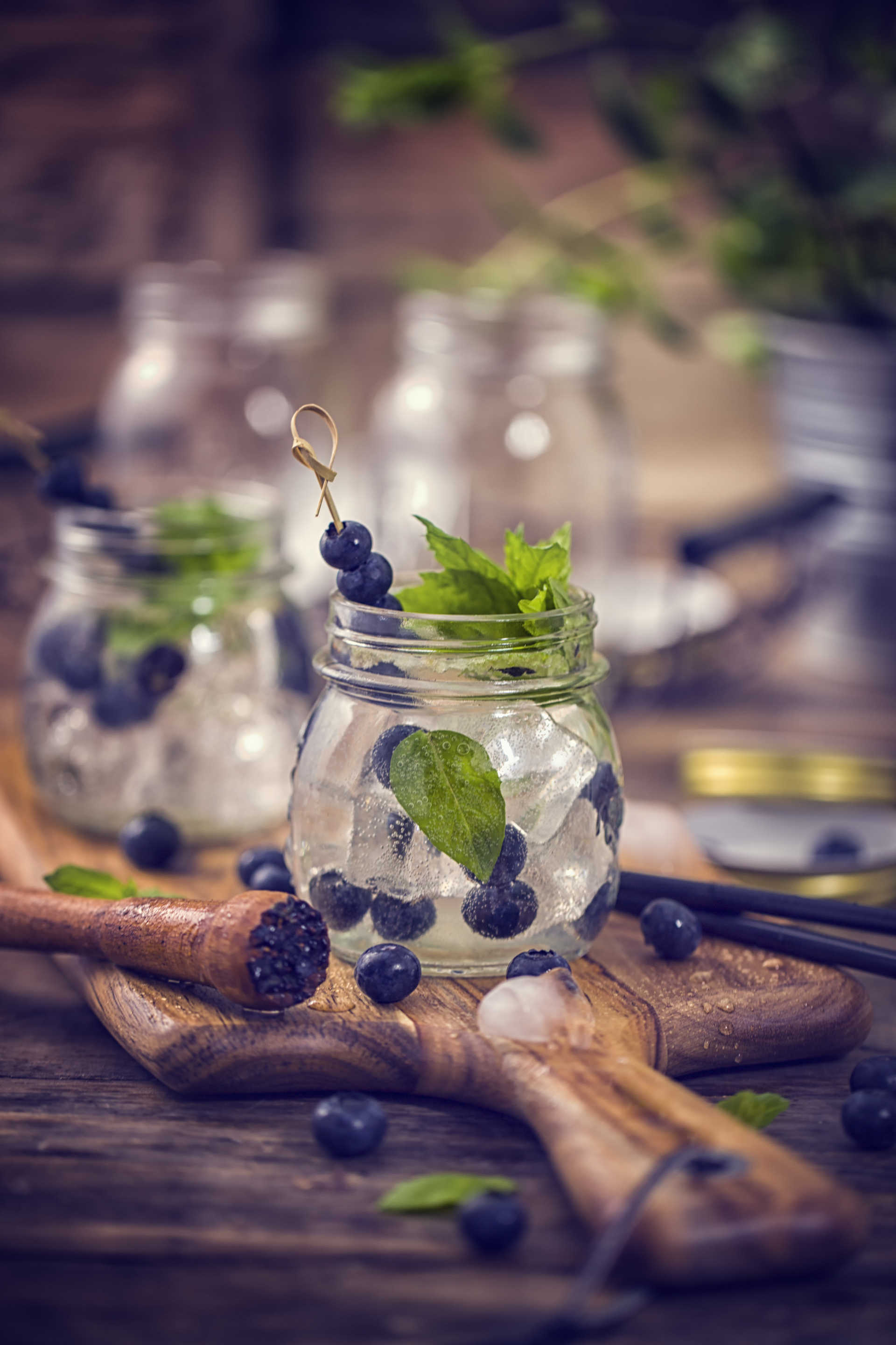 Blueberry Mint Mojito on a wooden serving platter with blueberries