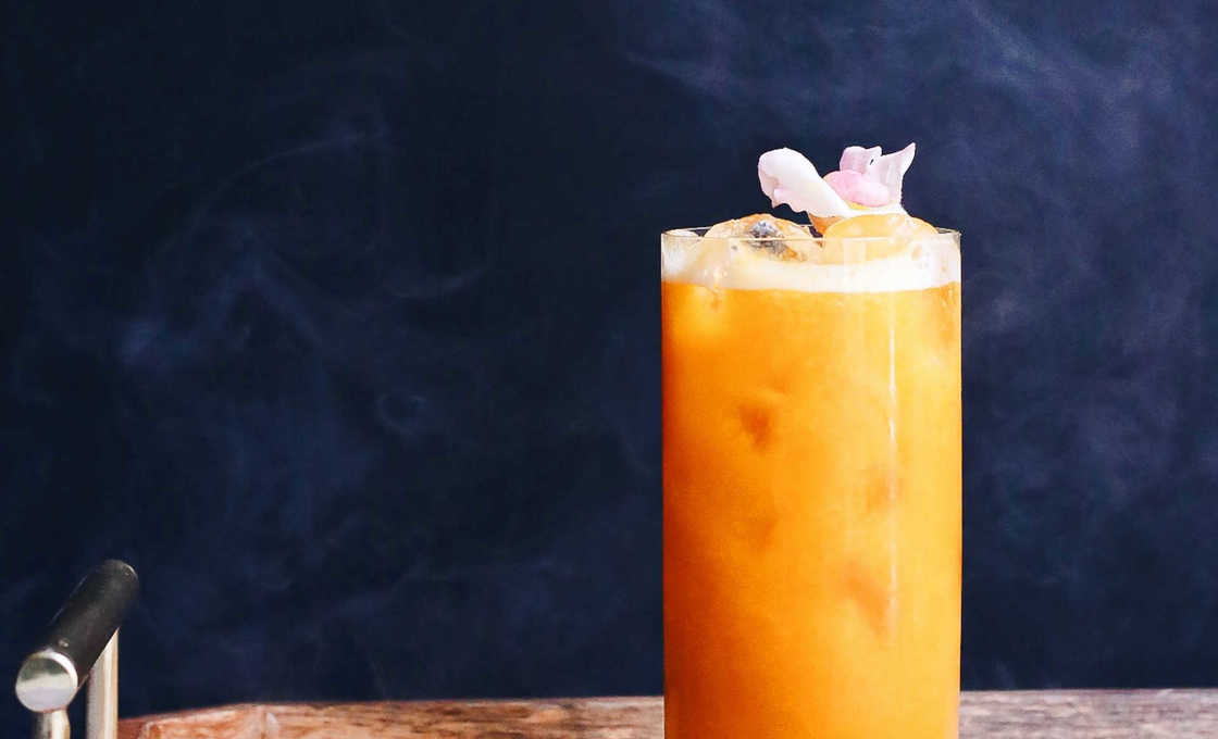 Glass of Sunset on a wooden tray