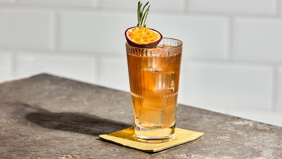 A glass of yuzu citron ginger tea on a stone surface
