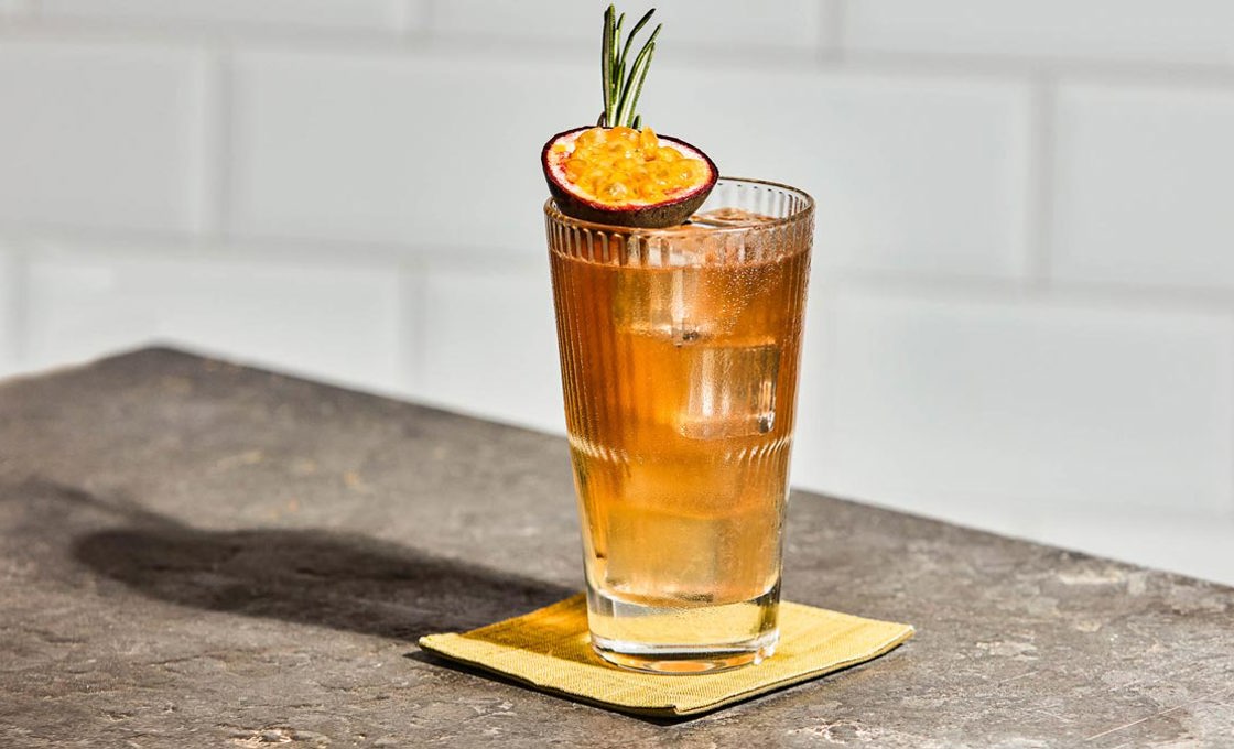 A glass of yuzu citron ginger tea on a stone surface