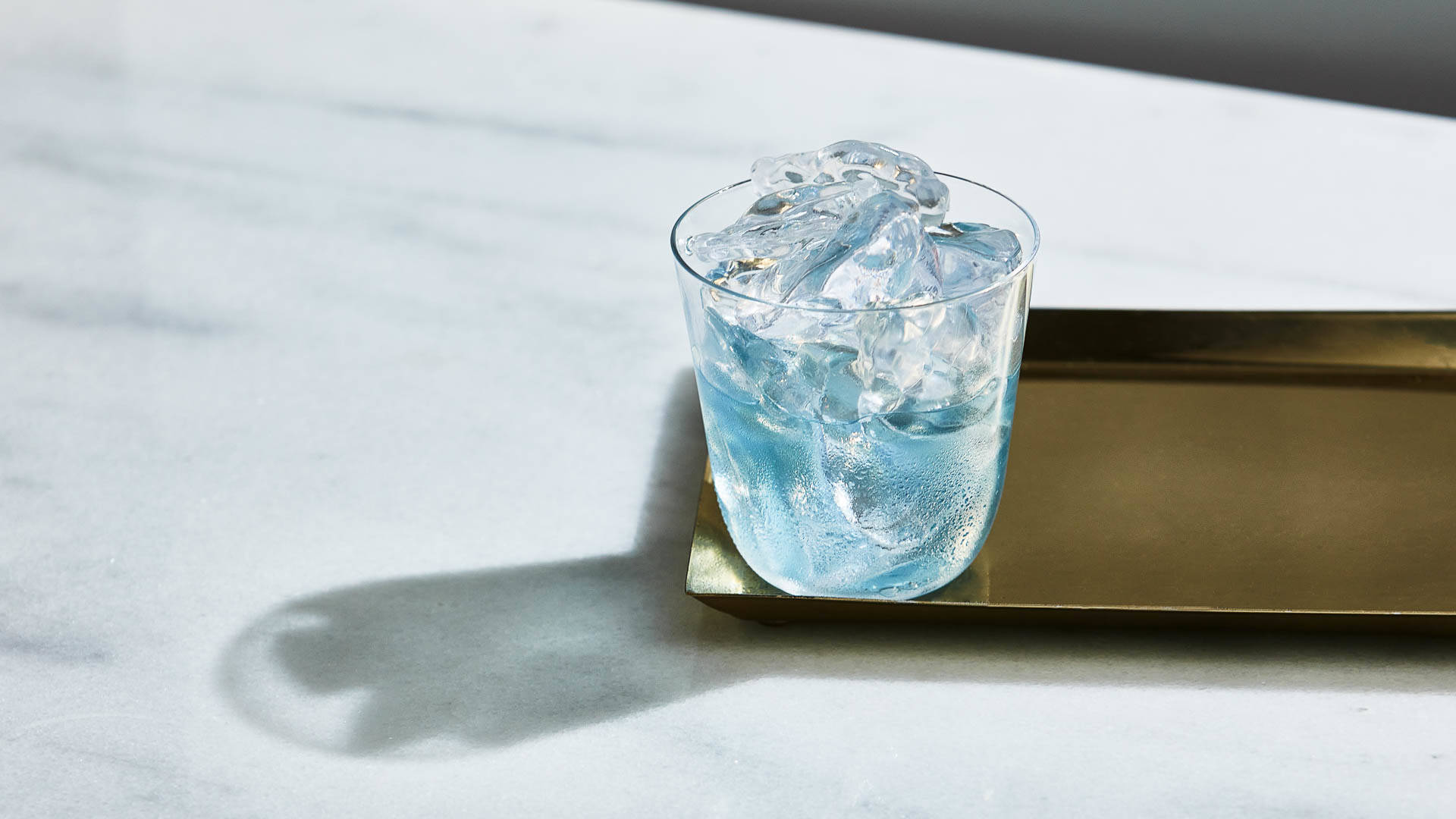 Glass of 3V on a serving tray