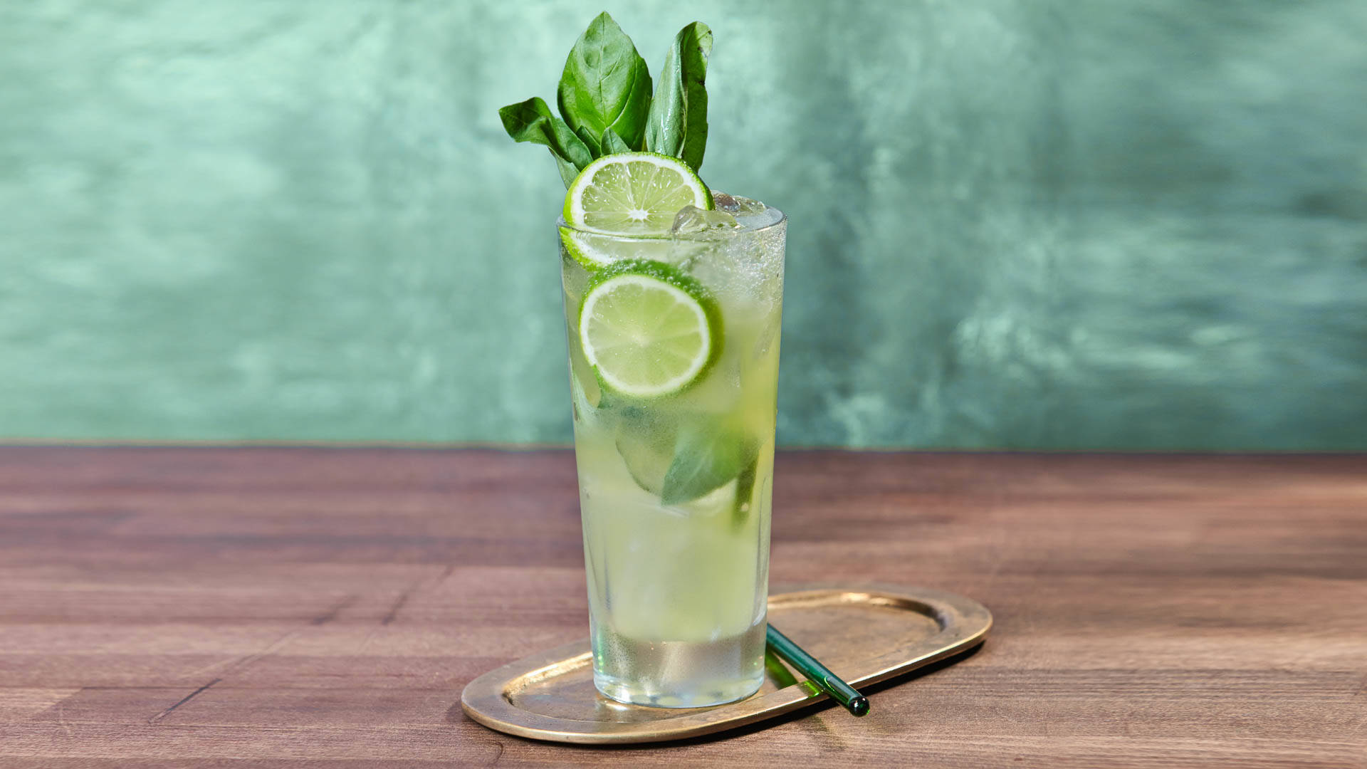 A glass of Virgin Basil Spritz on a metal serving plate
