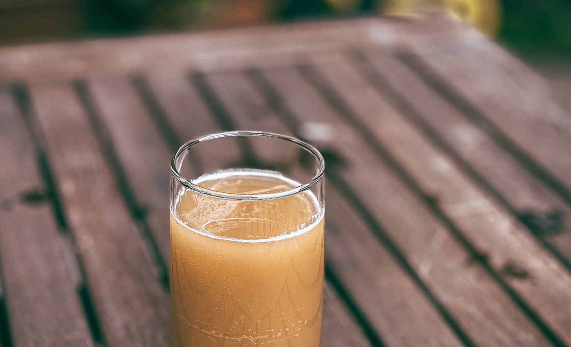Glass of American Pie No.2 on a wooden table outside