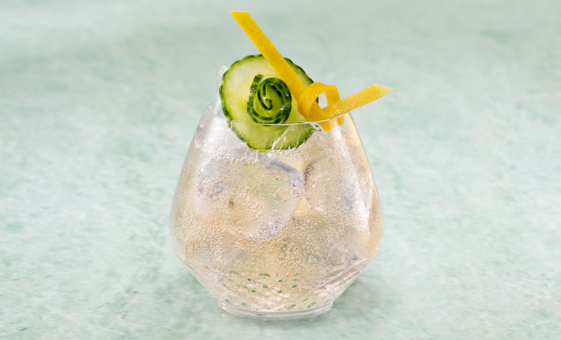 Yuzu And Cucumber Soda sitting on a green surface