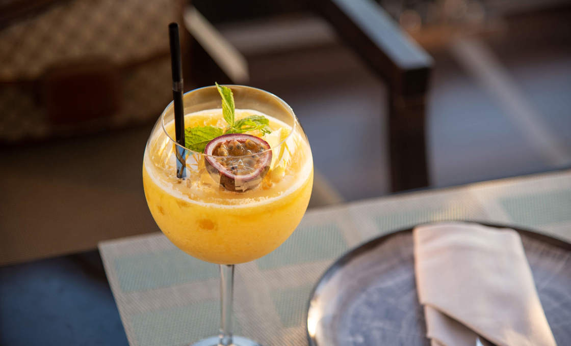 A glass of trio on a table with cutlery 