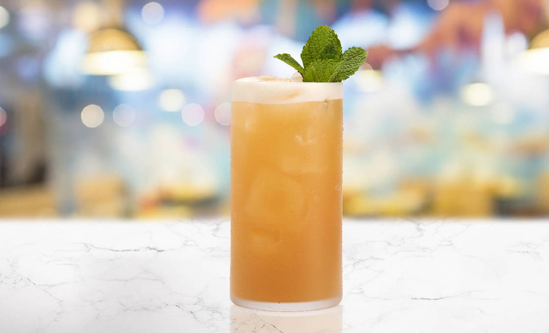 Glass of Tropicana on a marble table