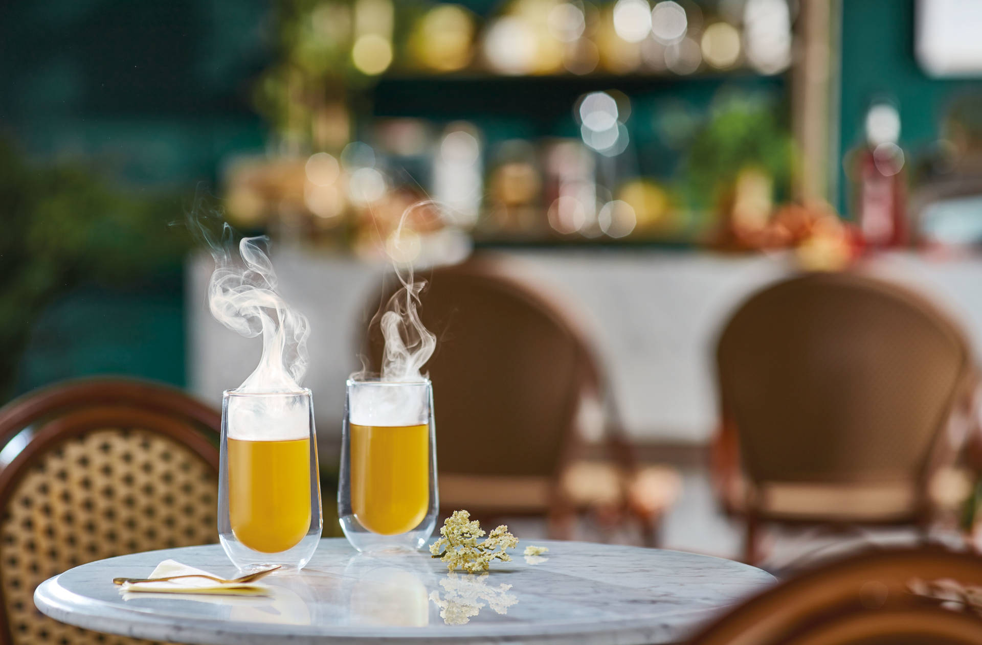 Two steaming glasses of Merry Me time on a marble table