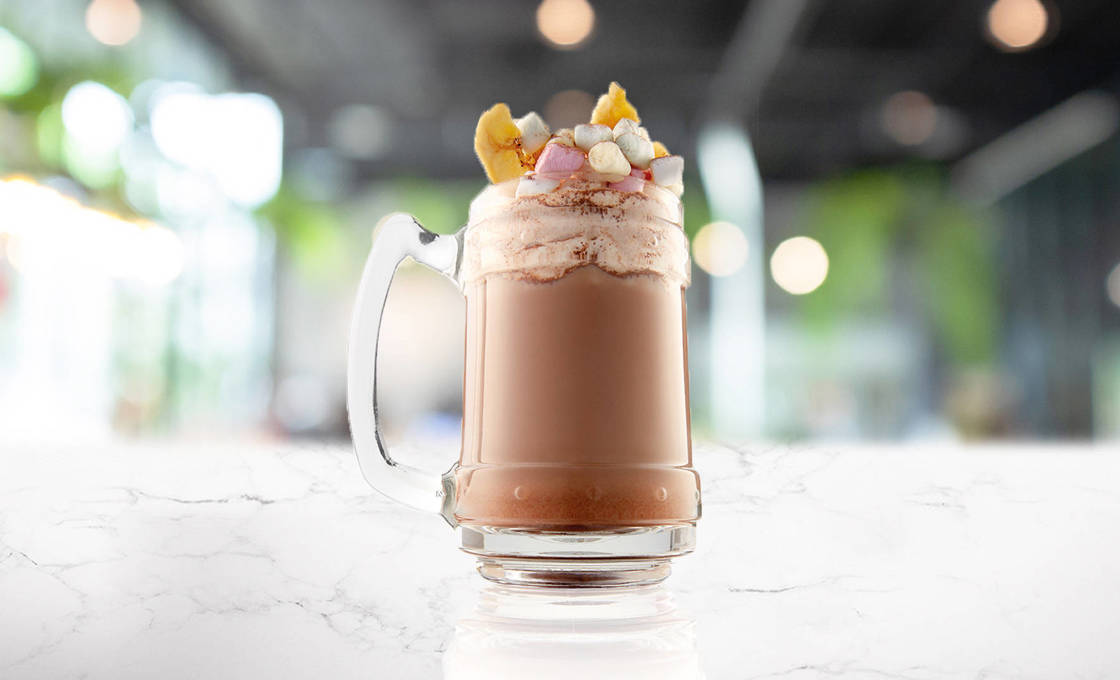 Glass of choco banana praline on a marble counter