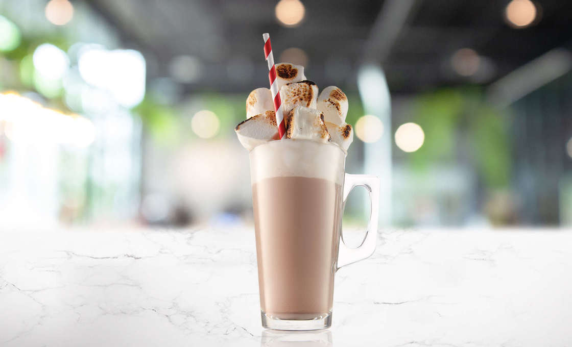 Glass of Popcorn Latte with popcorn garnish