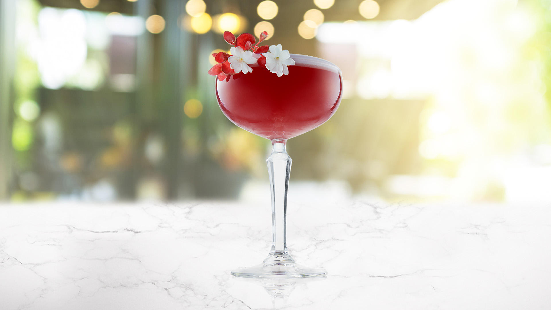 A glass of pink grapefruit and lychee martini on a transparent background