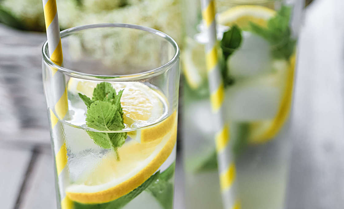 two glasses of Sparkling Elderflower tea on a wooden table