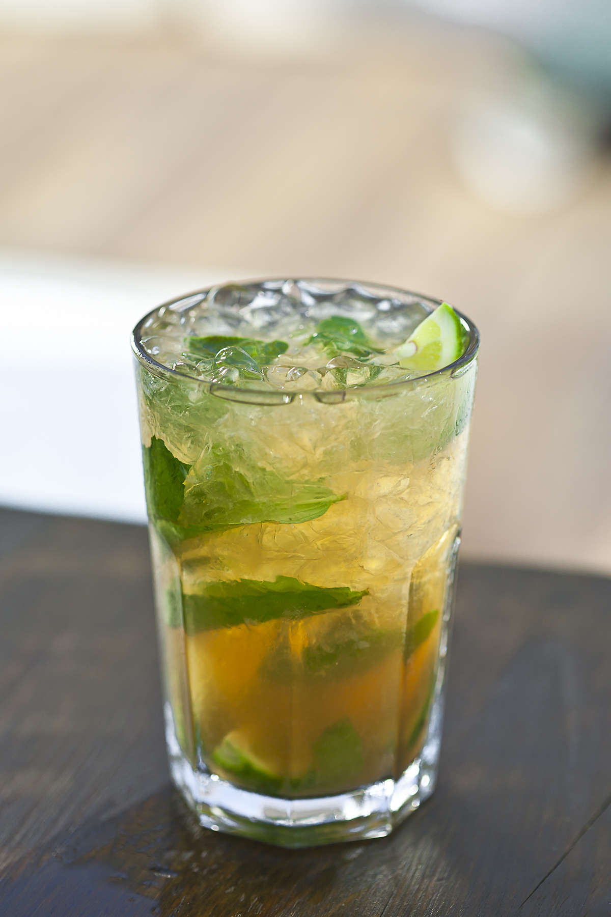 Glass of Triple Caiprinha on a wooden table