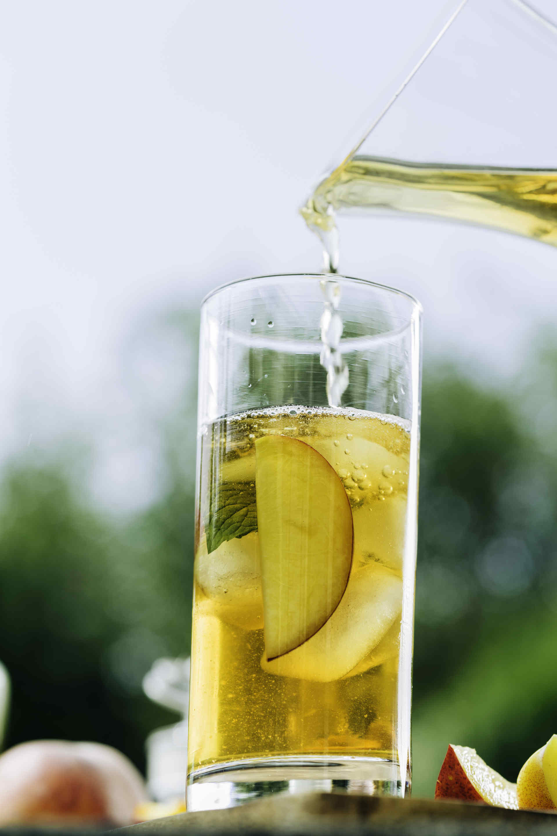 Pear And Apple Soda being poured into a glass