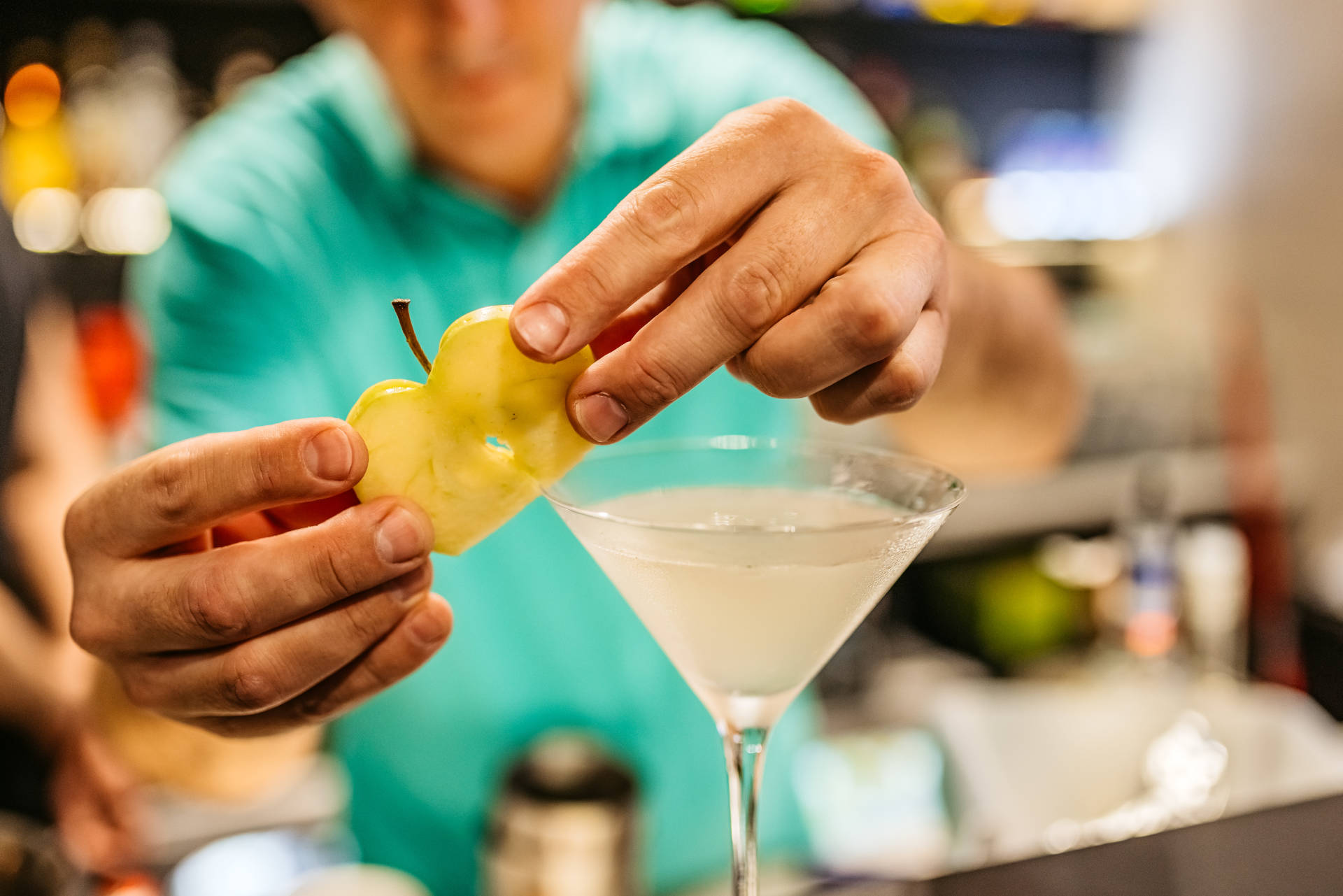 Bartender garnishing a Green Apple Margarita