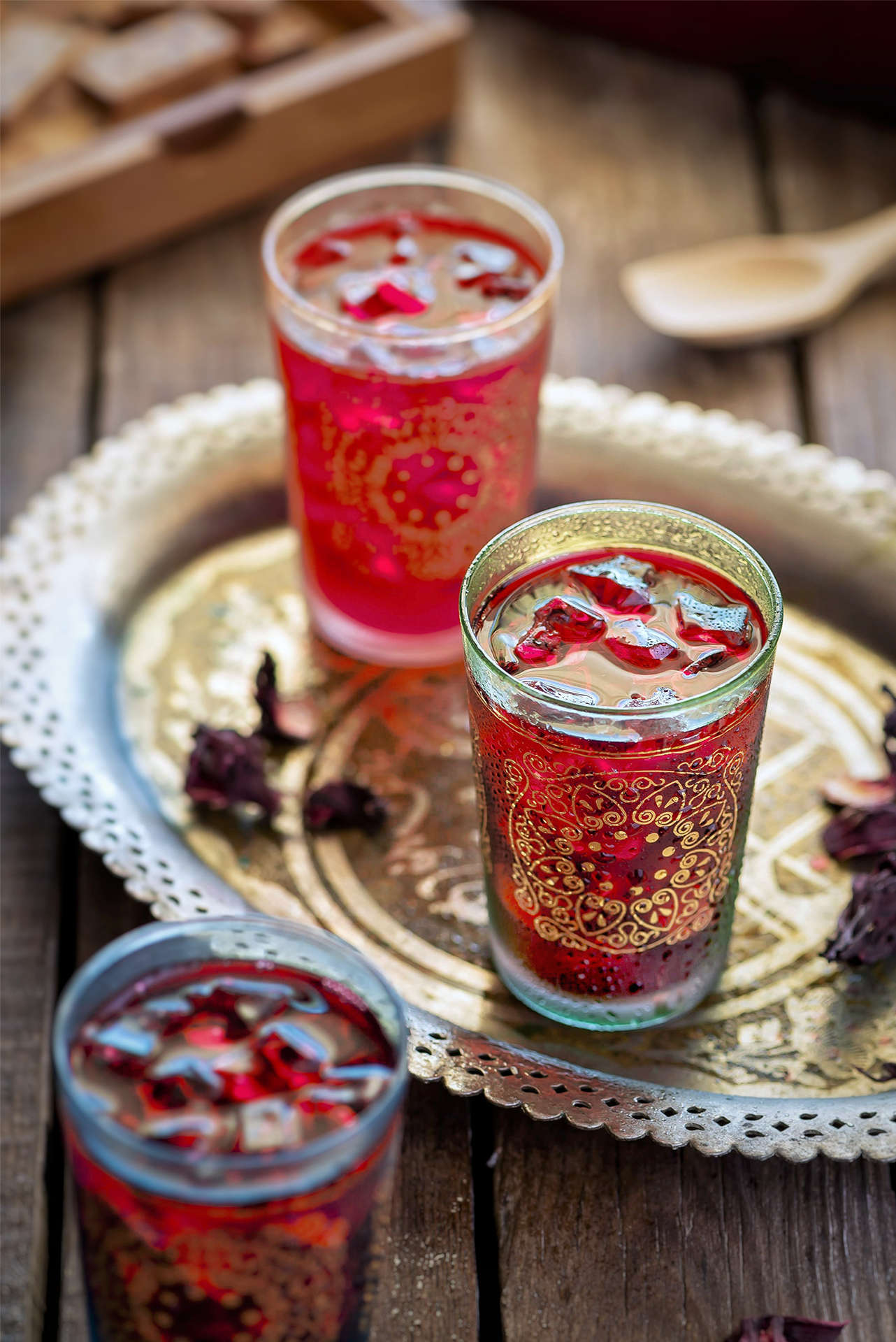 Three glasses of S Tea in glasses decorated with gold detail on a metal tray