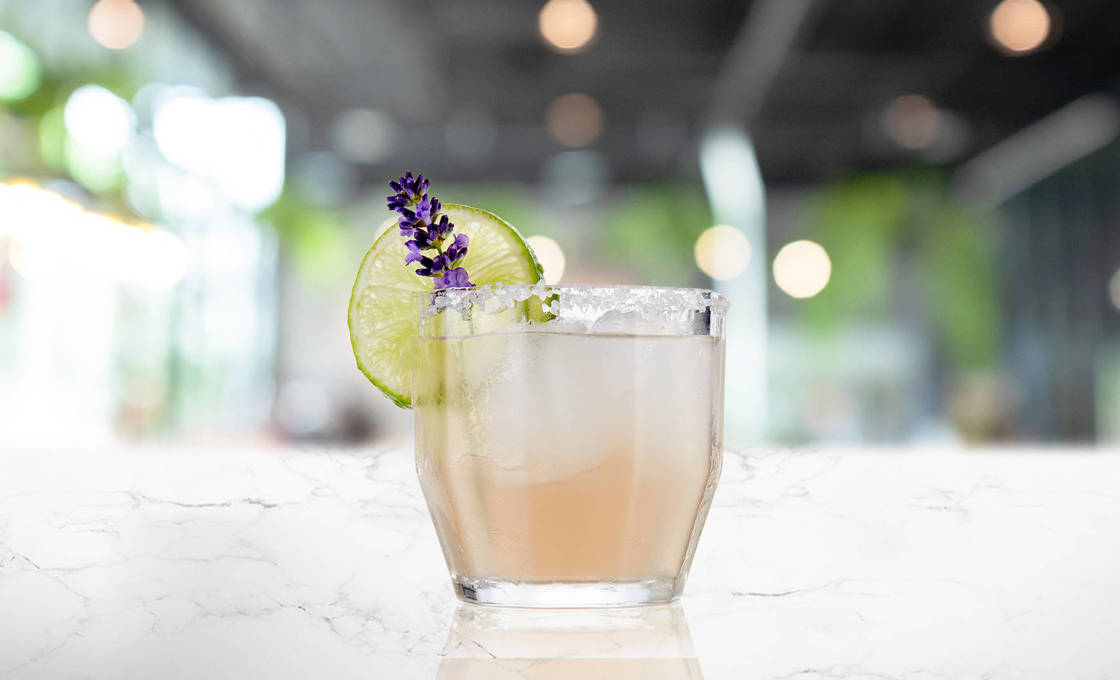 Glass of Lavenderita on a marble surface