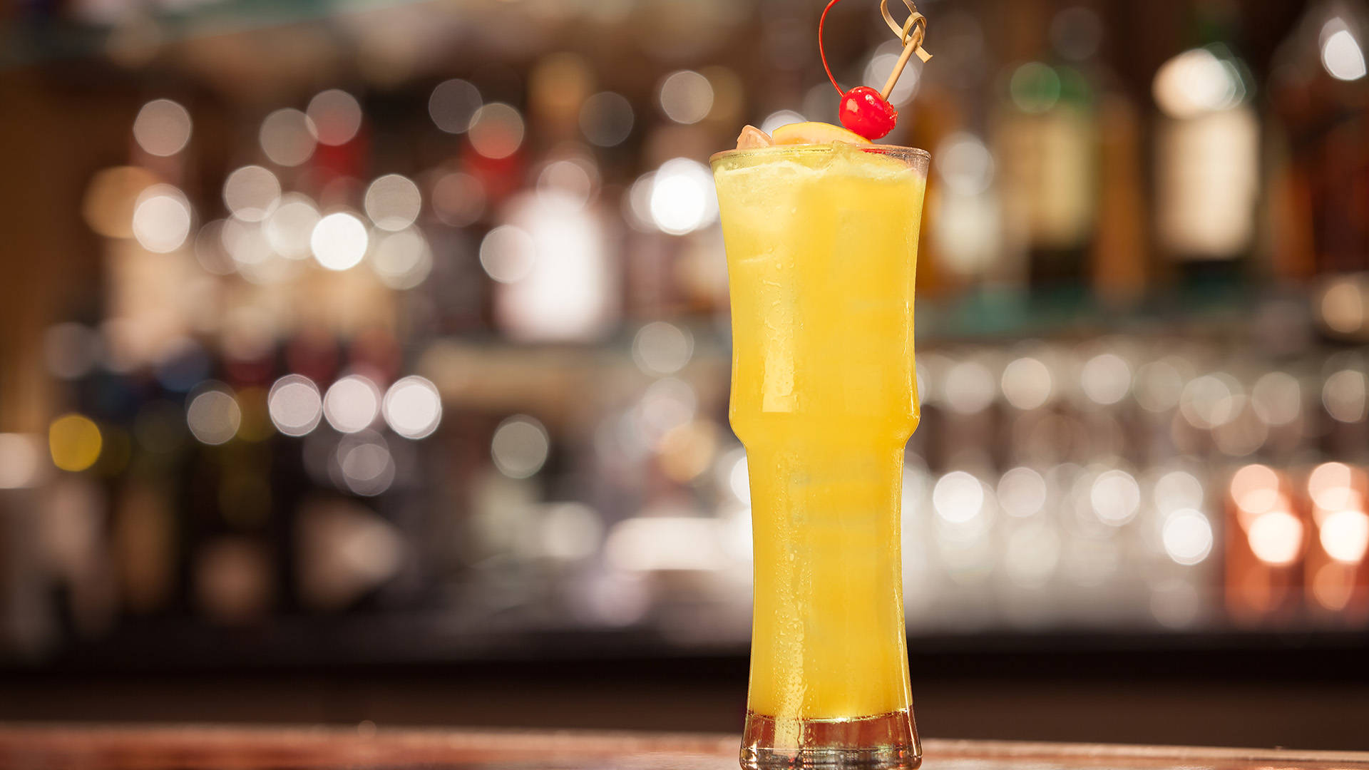 Tall glass of Cactus Orange Fizz in a bar context