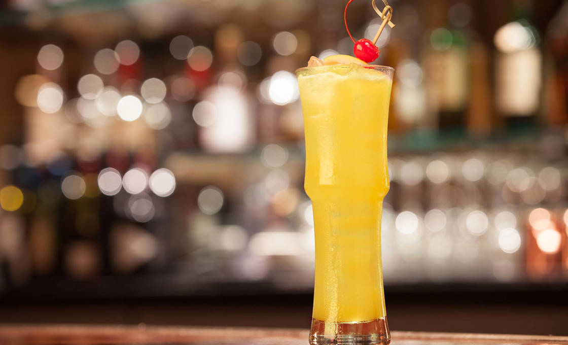 Tall glass of Cactus Orange Fizz in a bar context