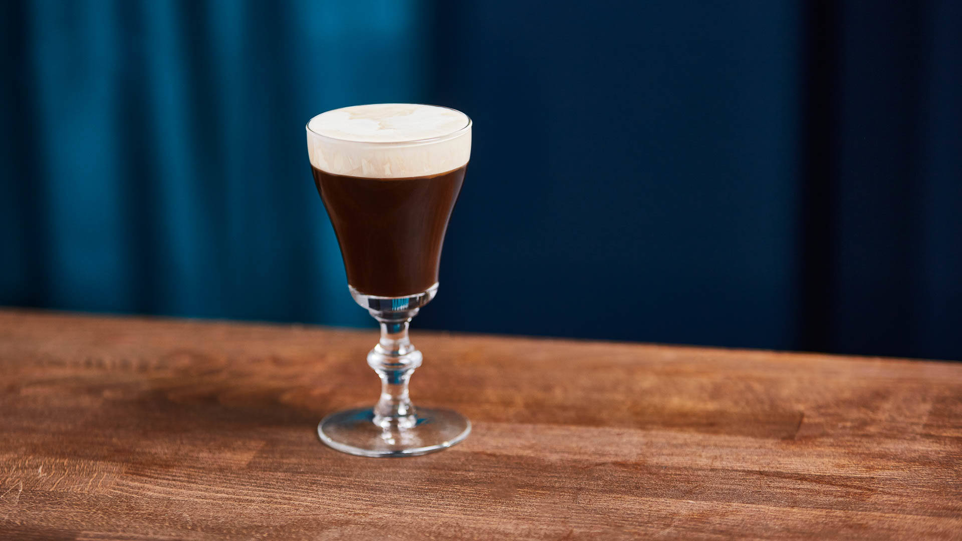 A glass of Irish Mist on a wooden table