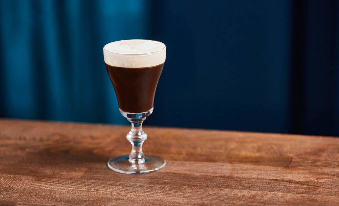 A glass of Irish Mist on a wooden table