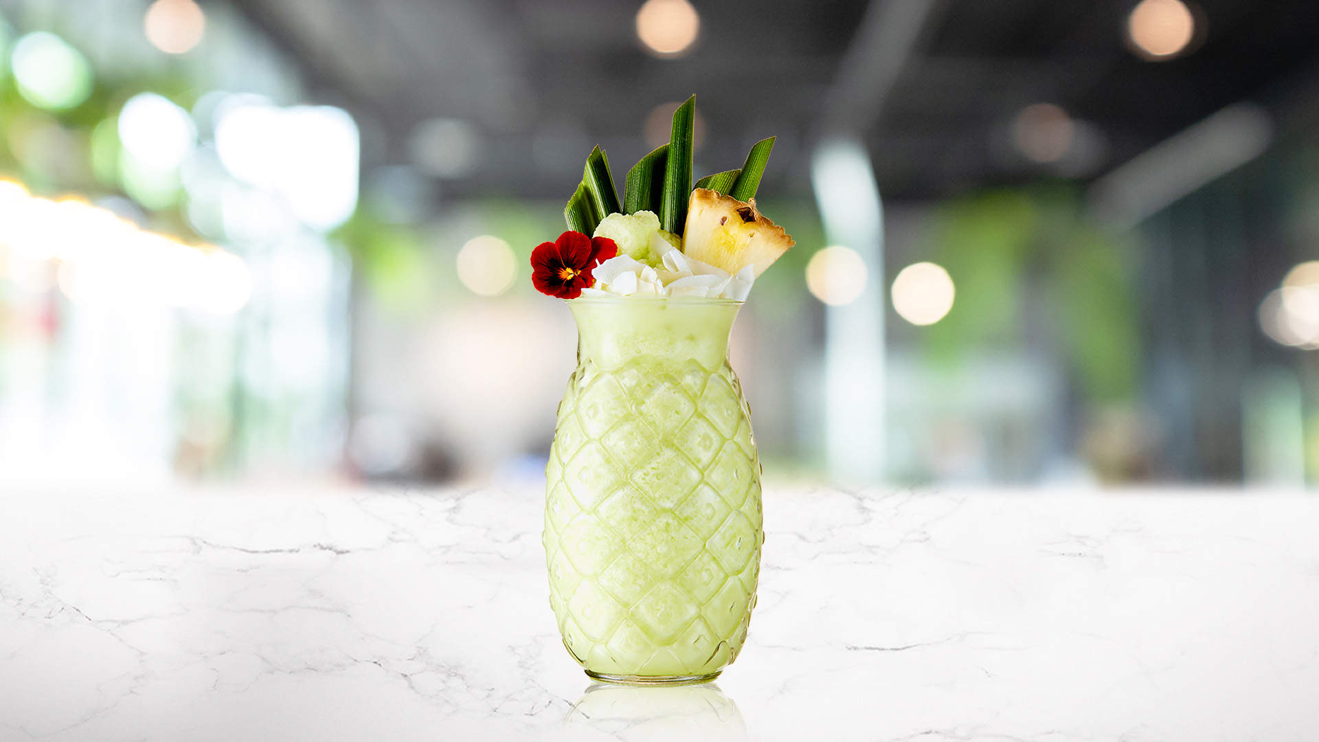 Glass of Pandan Colada on a marble counter