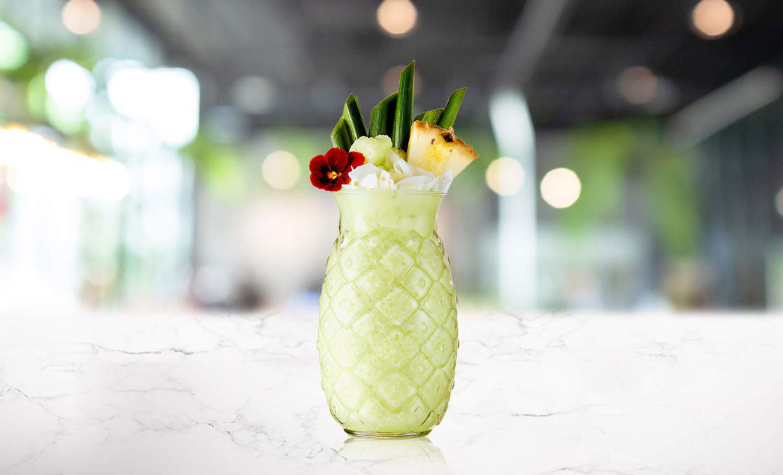 Glass of Pandan Colada on a marble counter